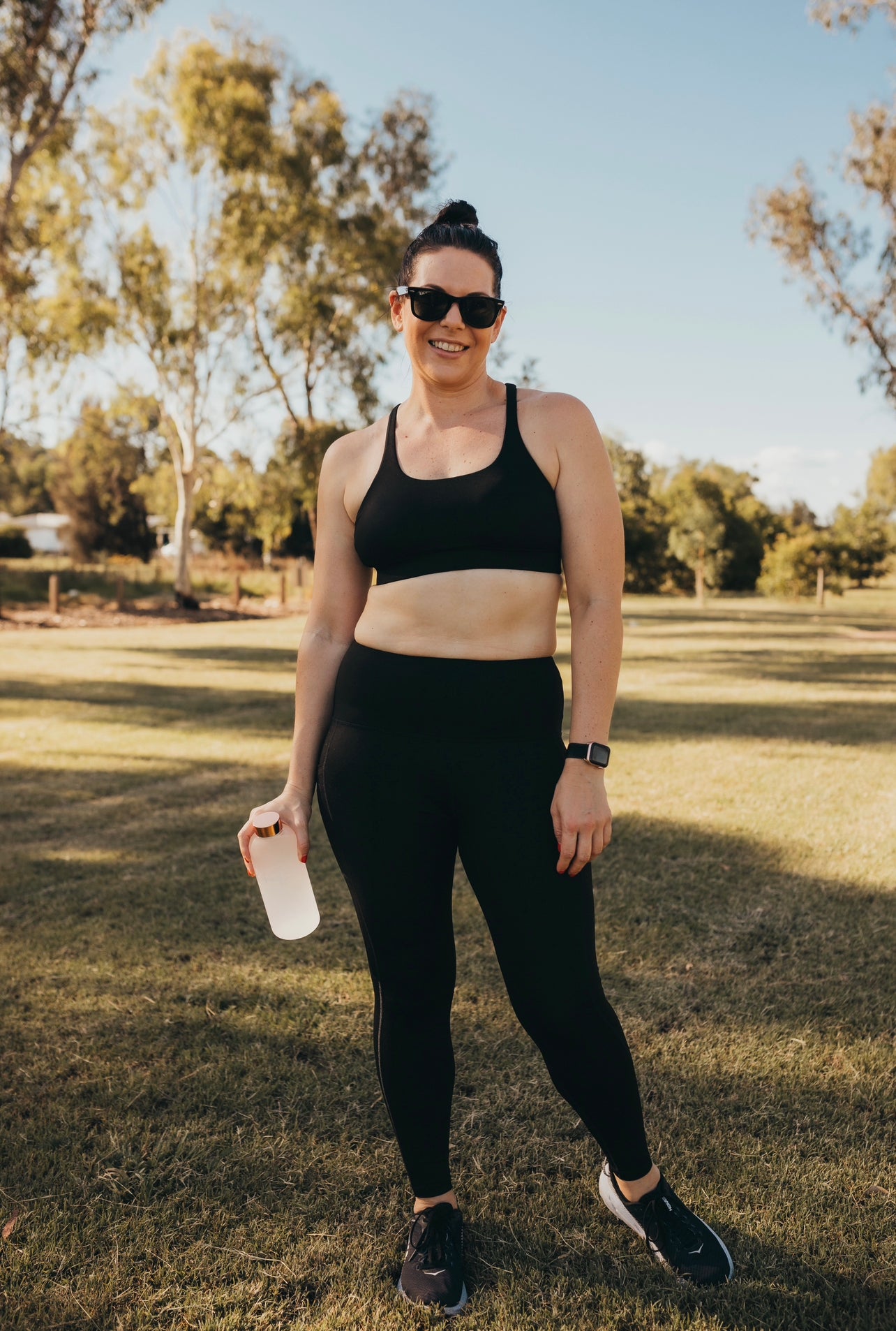 Women at the beach wearing the marlz and me Classic Black Cross Sports Bra and Classic Black Full Length Tights at the park on a beautiful sunny day.